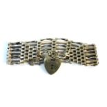 A gold seven bar gate link bracelet, with padlock, marked 9ct