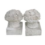 A pair of reconstituted stone finials, modelled as baskets of flowers, 38cm high, an elephant and