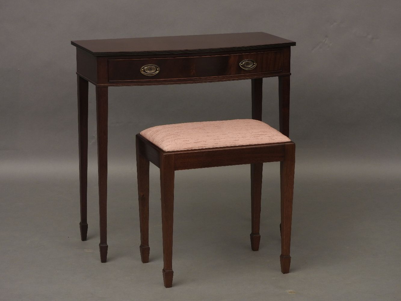 A Redman and Hales mahogany bow front side table, with single drawer, on square tapering legs, and a