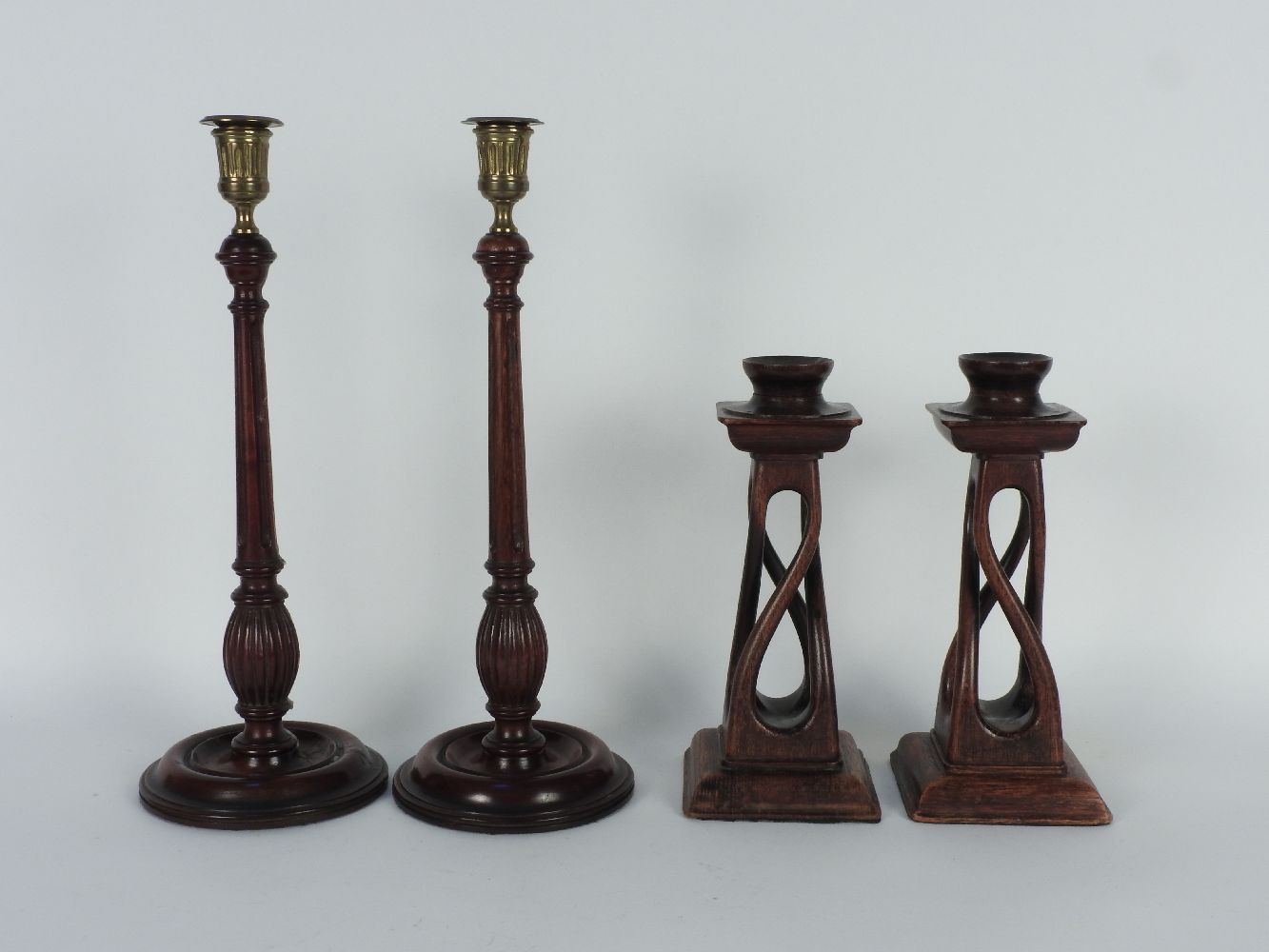 Two pairs of wooden candlesticks, tallest 37cm