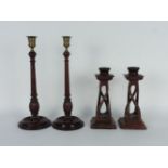 Two pairs of wooden candlesticks, tallest 37cm
