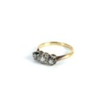 A gold three stone diamond ring, marked 18ct, 2.97g