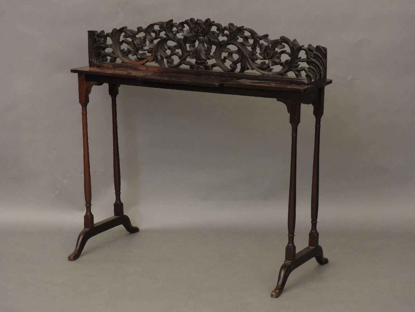 A pierced and carved pediment, 97cm and a reading table, with a ratcheted centre, 95cm wide (2)