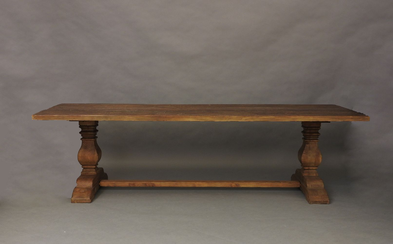 A large refectory table, raised on square baluster supports, 280cm long, 102cm wide