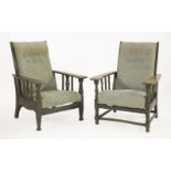 An Arts & Crafts oak reclining armchair, with paddle arms and fret cut splats, andanother, with