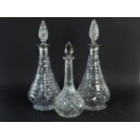 A pair of cut glass decanters with silver collars and one other decanter (3)