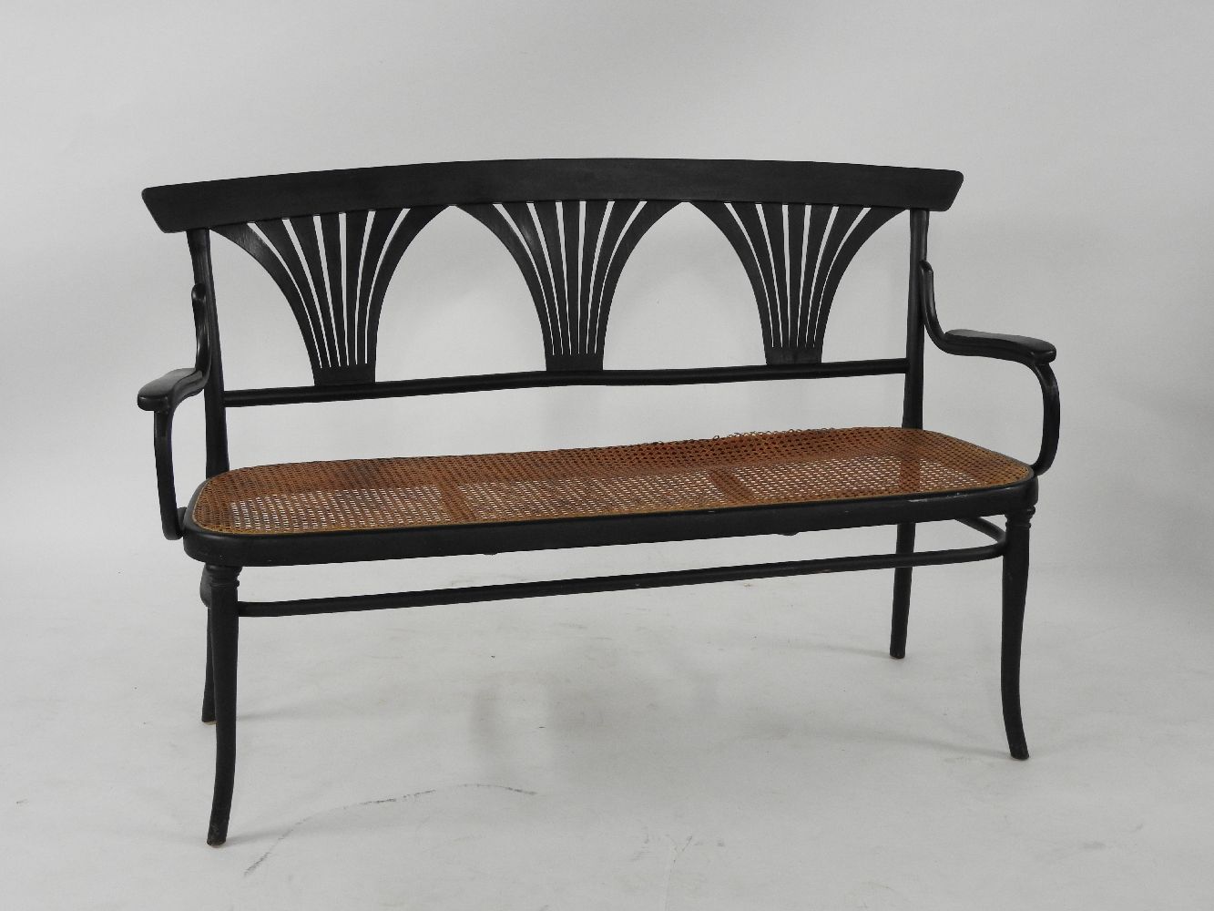 A Thonet ebonised bentwood settee, with three pierced and carved back splats, 146cm wide