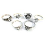 Two 9ct gold single stone cubic zirconia rings, two silver single stone rings set with simulated