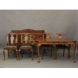 An early 20th century walnut dining room suite, comprising side board, extending table and four
