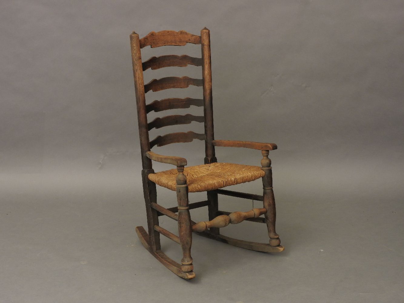 An elm and ash ladderback rocking chair