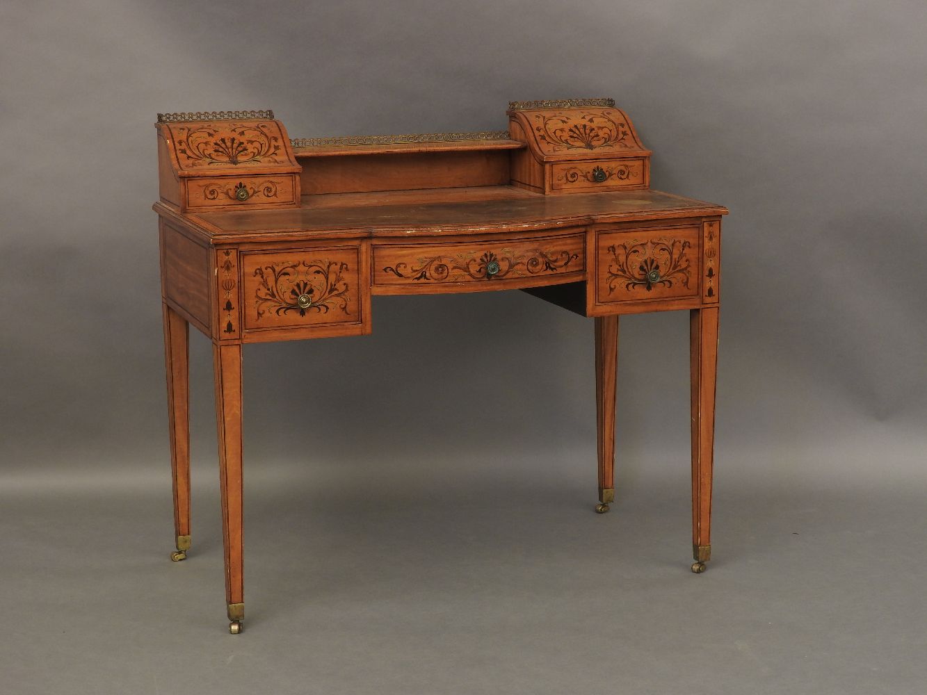 An Edwardian satinwood inlaid and leather top ladies writing desk, with letter compartments to the