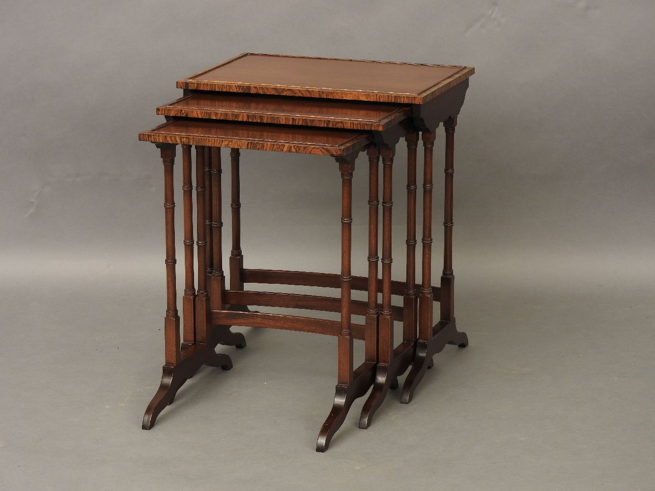 A mahogany and rosewood banded nest of tables, by Redman and Hales