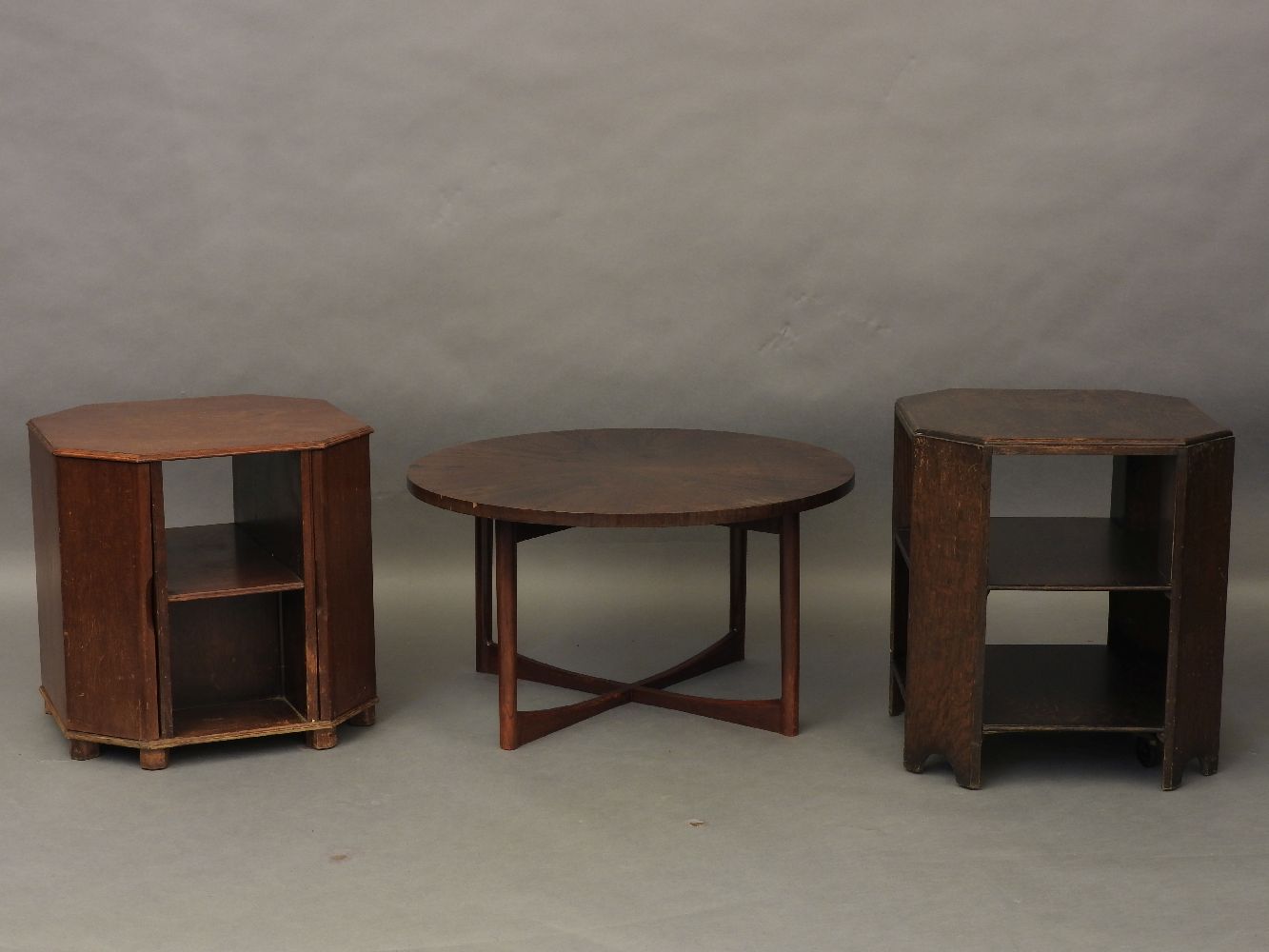 An A H McIntosh circular occasional table together with an octagonal table drinks cabinet/