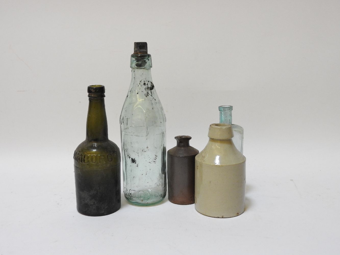 A collection of approximately thirty vintage coloured bottles