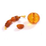 A large faceted amber bead, and carved amber bead caps