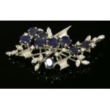 A Continental white gold, sapphire and diamond spray brooch, circa1970, with graduated oval mixed