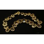 A late Victorian gold and citrine graduated riviere necklace, with a series of graduated oval