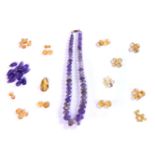 A large quantity of citrine and amethyst loose beads, including a single row faceted graduated