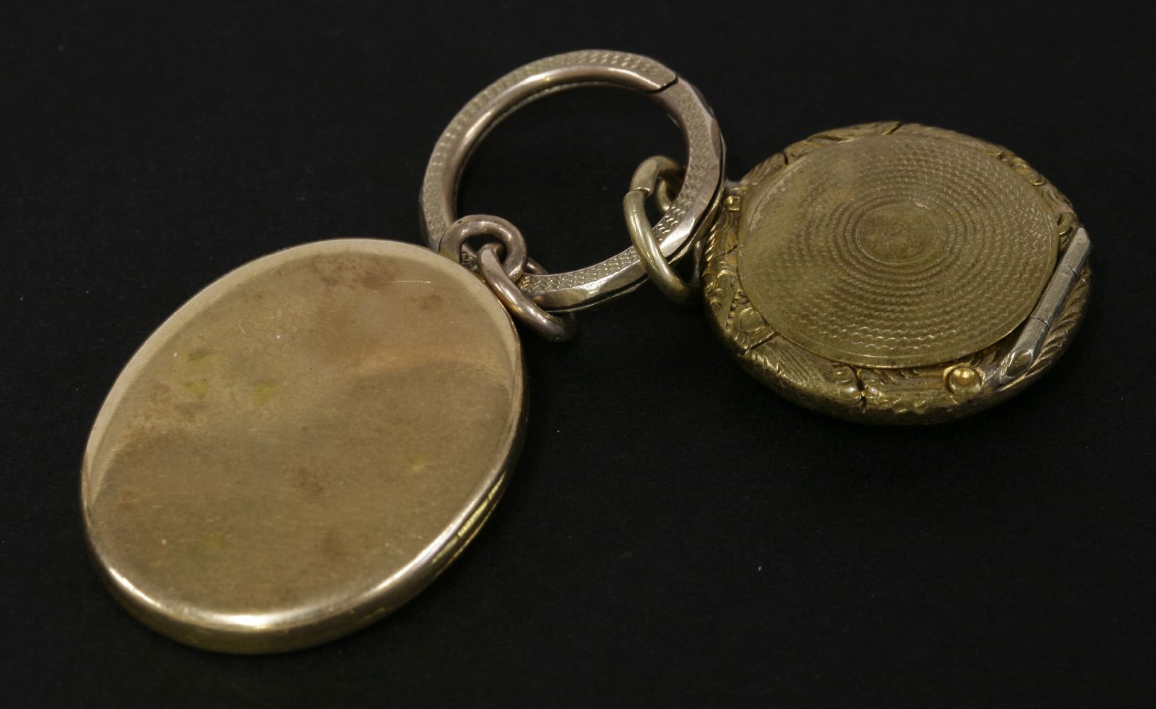 A Victorian gold oval locket, with engraved inscription, tested as approximately 18ct, and a gilt