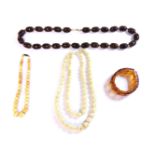 A collection of assorted beads and necklaces, to include loose carved nut beads, large early plastic