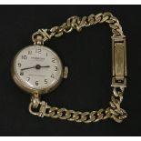A ladies 9ct gold Ingersoll mechanical watch head, with silvered dial and Arabic numerals, and a