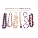 A large collection of wooden beads and necklaces, to include carved wooden examples, a single row of