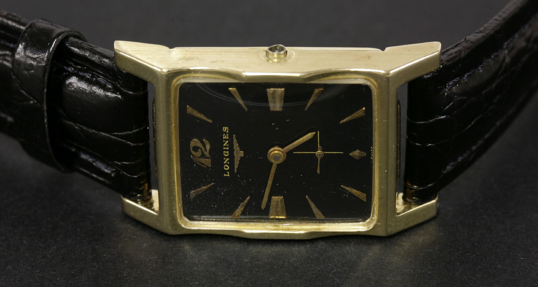 A Longines gold American market mechanical strap watch, with a black enamel dial, gilt hands and - Image 2 of 2