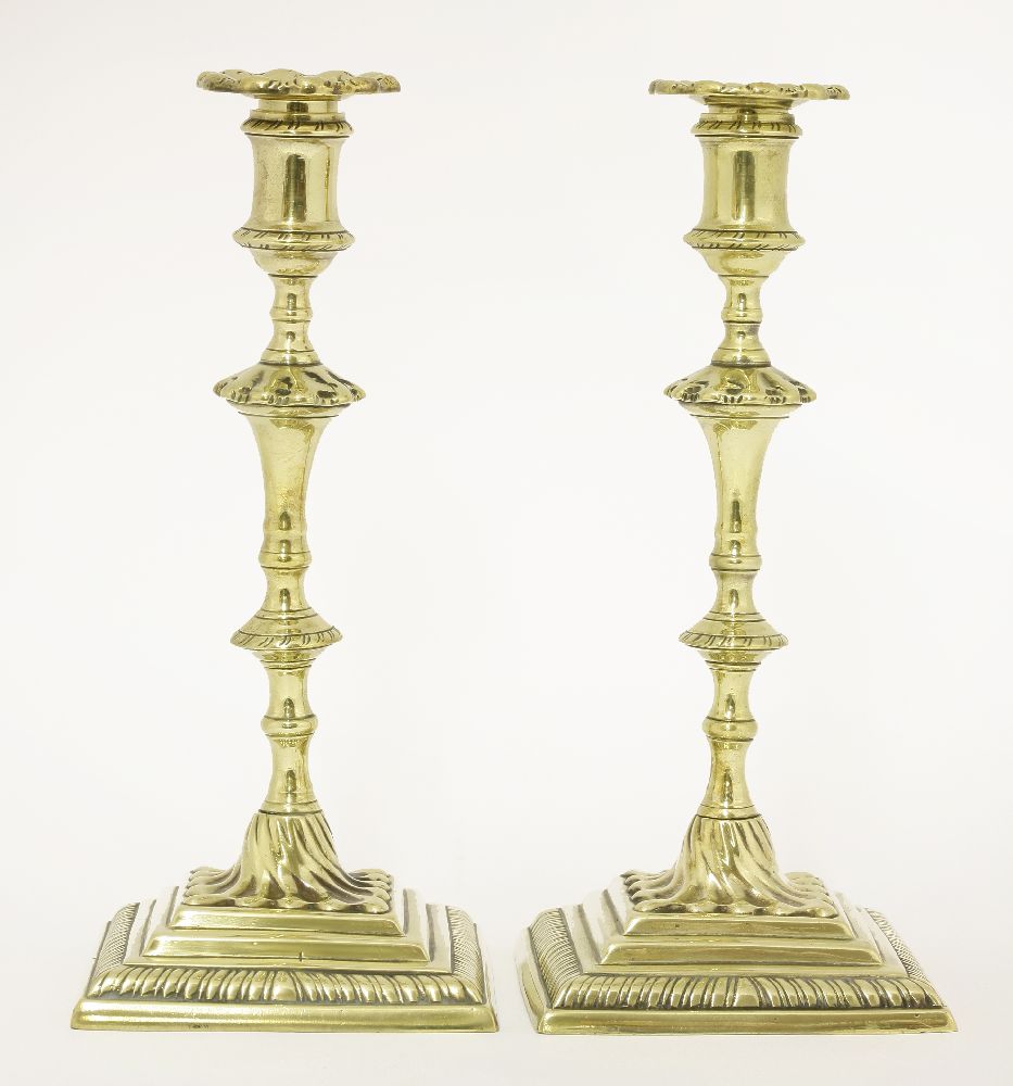 A pair of brass candlesticks,mid-18th century, with square gadrooned bases,25cm high (2)