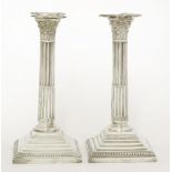 A pair of silver candlesticks,John Collard Vickery, London 1909,of Corinthian column form, raised on