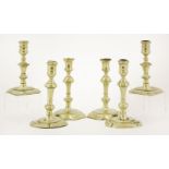 Three pairs of brass candlesticks,early to mid-18th century, with canted square bases,15 to 17.5cm