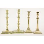 Two pairs of brass candlesticks,mid-18th century, with turned or baluster stems,23 and 26cm high (