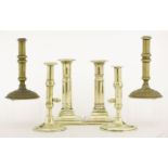 A pair of brass candlesticks,mid-18th century, with acorn push-up ejectors and with stems on