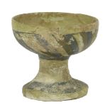 A Syrian/Egyptian earthenware pedestal cup,12th century, glazed in gold and blue, repaired, 10.7cm