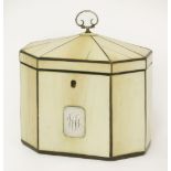 A George III ivory tea caddy,of octagonal form, the panelled lid with a scrolling silver handle, the
