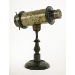 A Victorian kaleidoscope,with a metallic finish tube on a turned and ebonised stand,31cm hightube