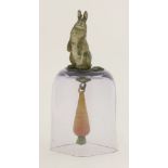 A cold painted bronze bell,the handle modelled as a cold painted rabbit standing on a leaf mount,