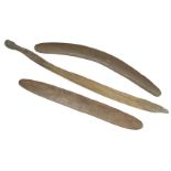 Three Aboriginal hardwood items:a boomerang,62cm long,a bullroarer, with carved decoration to each