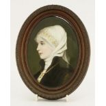 A German porcelain oval plaque,19th century, a portrait of a young woman with white headdress,