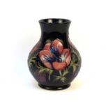 A large Moorcroft Anemone Blue pattern vase, signed, the blue ground with flowers in pink and purple