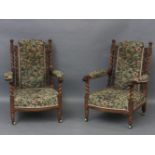 A pair of Victorian carved oak arm chairs, with twist turned uprights