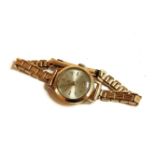 A ladies 9ct gold Tudor mechanical strap watch, with later 9ct bracelet, silvered dial and baton