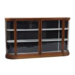 A Victorian mahogany glass fronted display cabinet, with a pair of central doors with bowed ends,