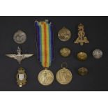 A collection of militaria, including general service medals, buttons and cap badges etc