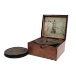 A late 19th century and walnut cased Kalliope table top musical disc player, fitted steel comb