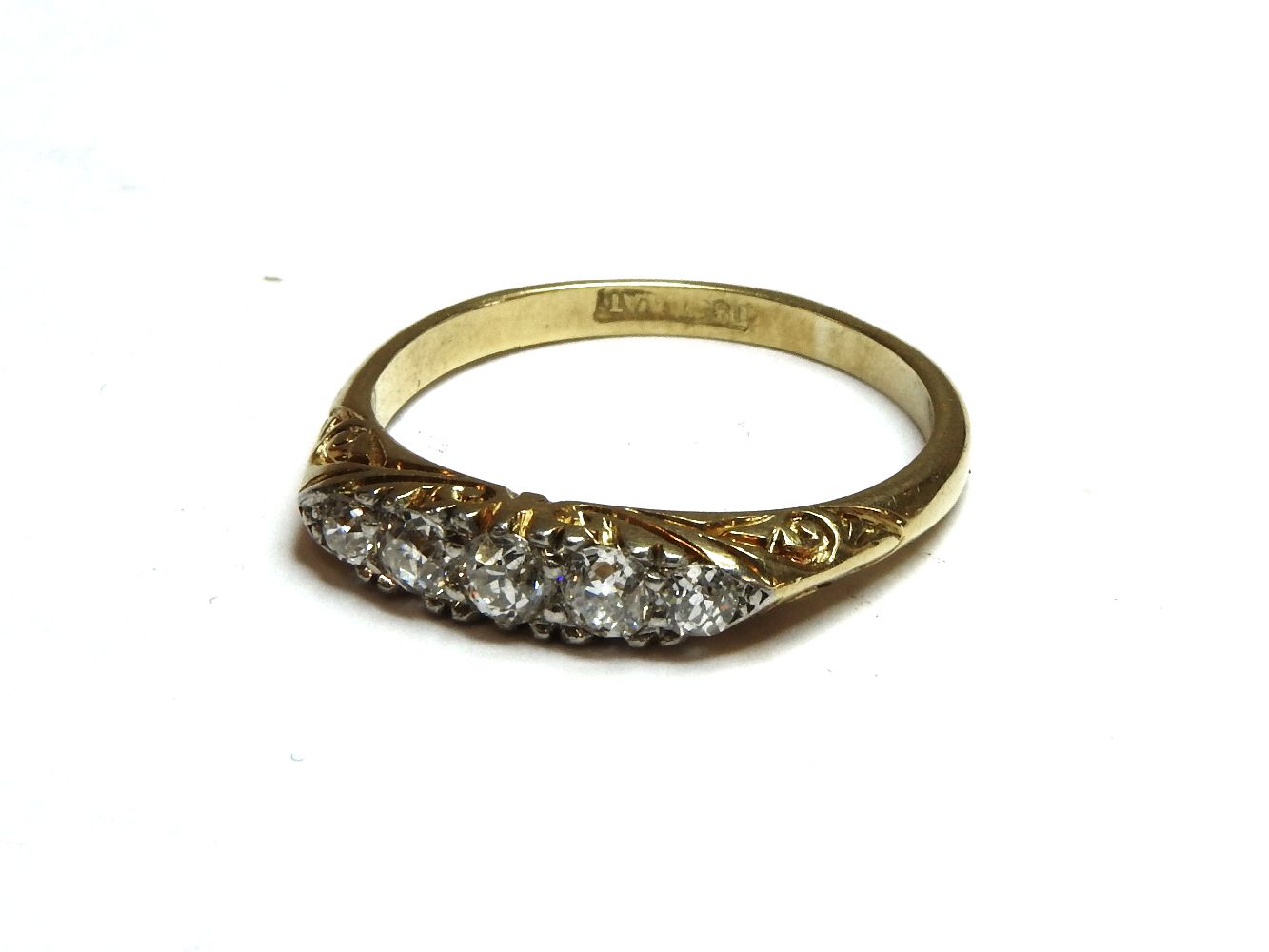 A gold boat shaped five stone diamond ring, marked 18ct and plat, 2.95g
