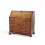 A George III mahogany bureau, of usual form with a slope front over four graduated drawers, 105cm