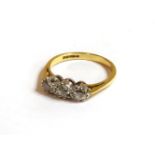 An 18ct gold three stone and old European cut diamond ring, 2.48g