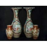 A pair of Kutani porcelain vases, with lion mask handles to either side and decorated with