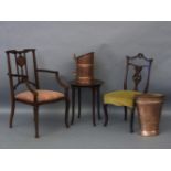 A copper coal bin, another container, two armchairs, and a thonet style table