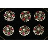 A cased set of six former Austro-Hungarian Empire garnet and enamel buttons, c.1900, each button